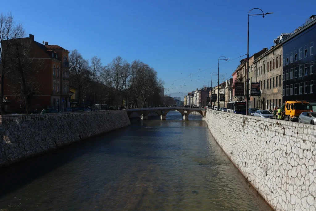 A riverside view of historic buildings in Sarajevo