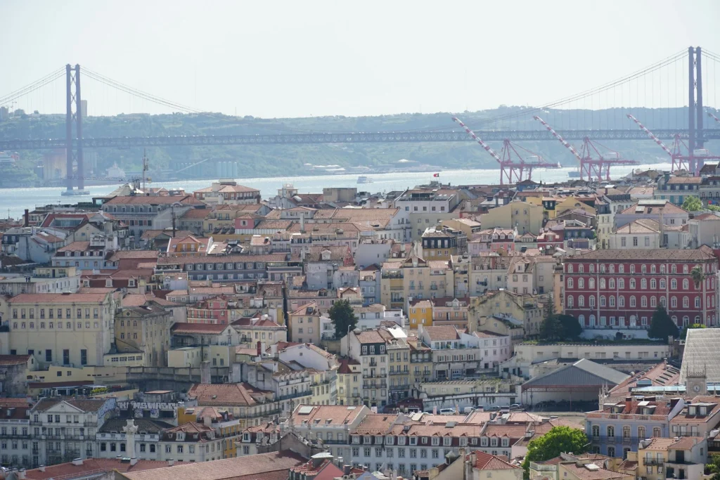 Lisbon rooftops with the river and bridge beyond, Portugal