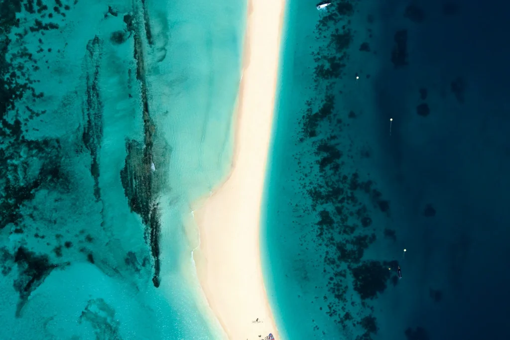 A white sandbank surrounded by turquoise water in Zanzibar